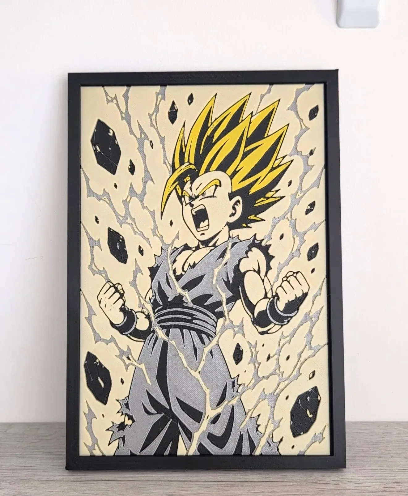 Black box with a yellow-haired warrior shouting, fists clenched and cracks of light on a cream background.