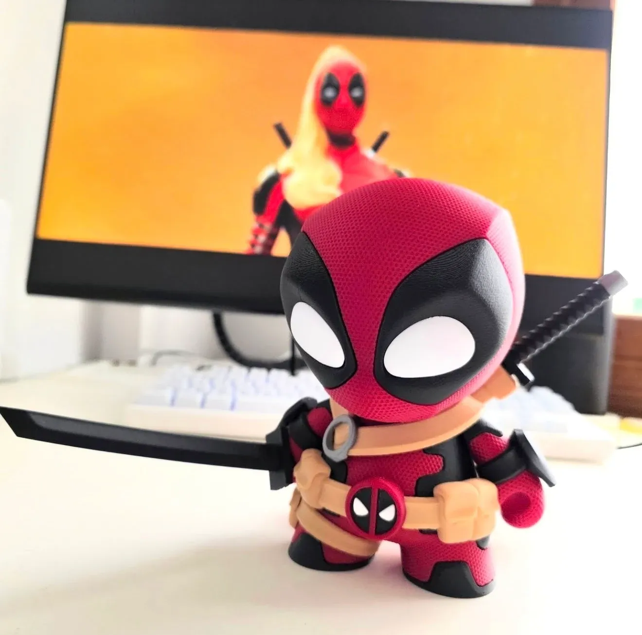Figura de un mercenario bocazas enmascarado en rojo y negro, con cinturón beige y empuñaduras de espada sobre los hombros.